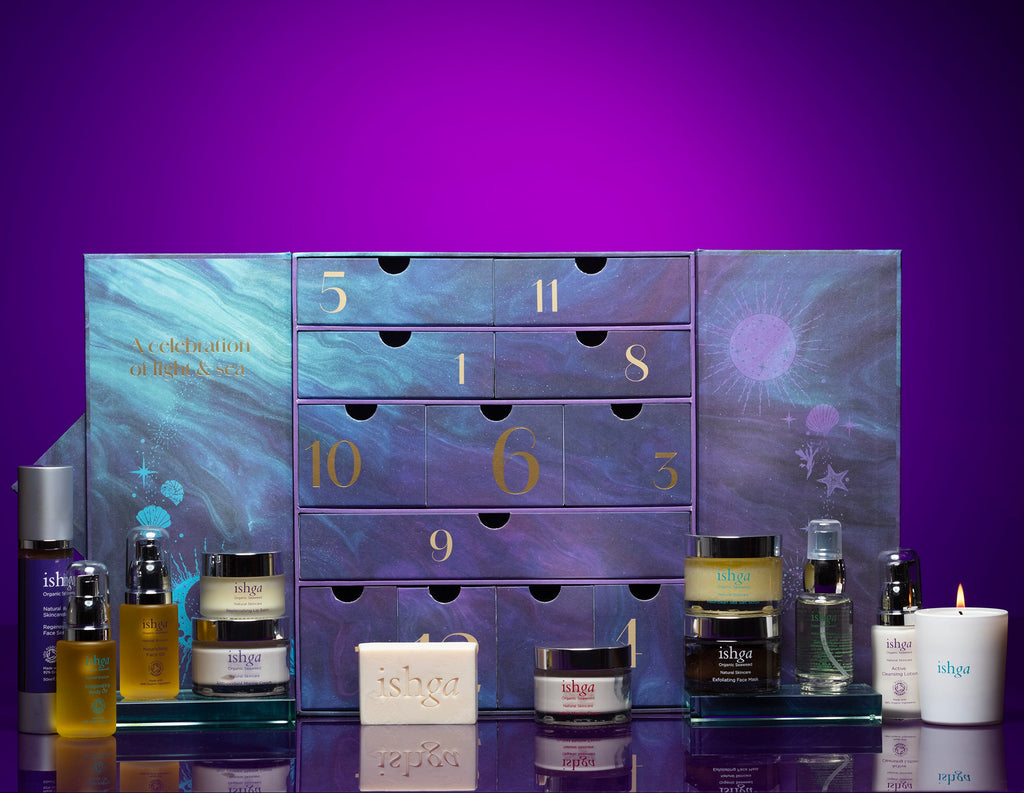 Cosmetic advent calendar with drawers and skincare products on a purple background