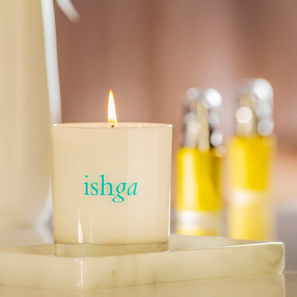 ishga Hebridean Dreams Candle opened with the flame lit, on top of a shelf