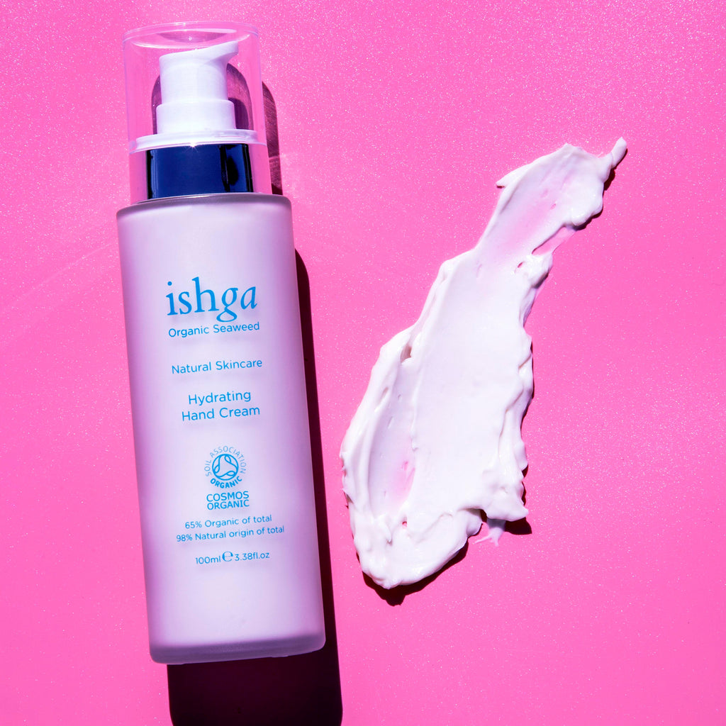 Bottle of ishga Hydrating Hand Cream with a sample of the cream next to it