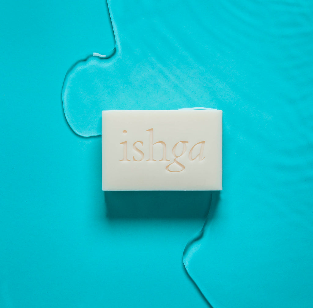 ishga Shampoo & Body Bar next to some water