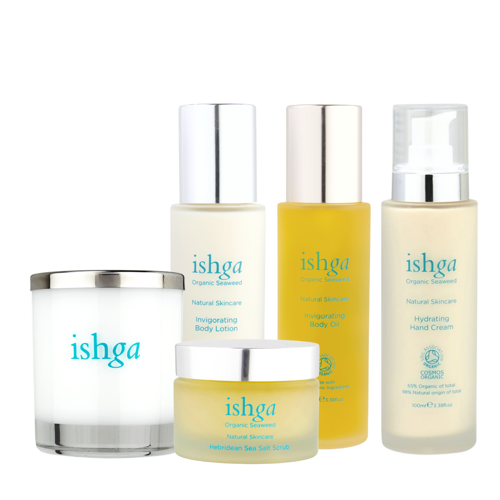 ishga Invigorating Body Collection which includes a Hebridean Candle, jar of Hebridean Sea Salt Scrub, bottle of Invigorting Body Lotion, bottle of Invigorating Body Oil, and a bottle of Hydrating Hand Cream 