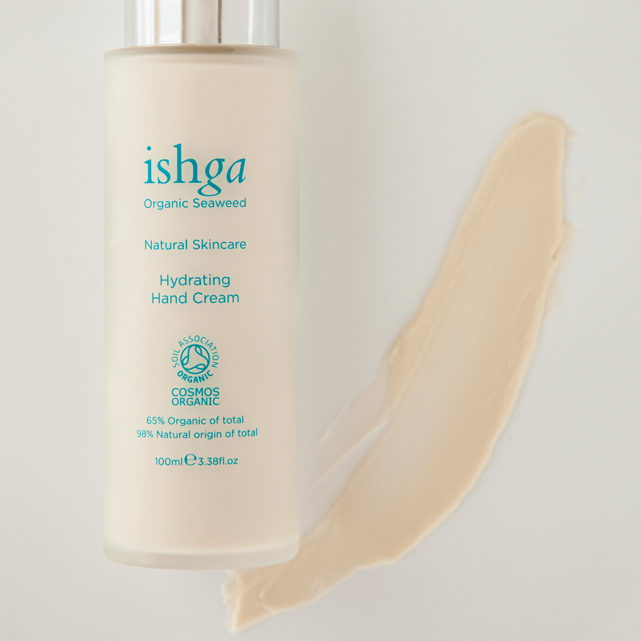 Bottle of ishga hydrating Hand Cream next to a sample of the cream