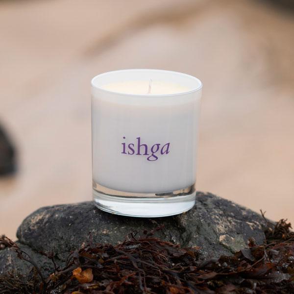 ishga Hebridean Aura hand poured seaweed candle with no lid placed on a rock